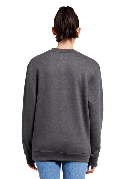 Back view of a woman wearing a grey charcoal sweatshirt featuring a striking painting-style paintover graphic of a man or woman wearing a coat with red nails and red lips. This piece blends the world of art and fashion, standing out among trendy attires you only discover in artist studios.