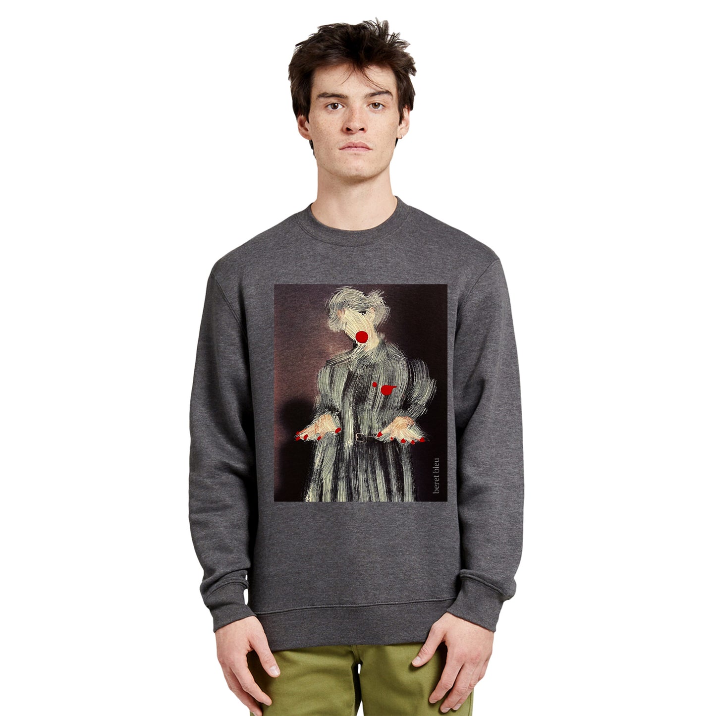 Front view of a man wearing a grey charcoal sweatshirt featuring a striking painting-style paintover graphic of a man or woman wearing a coat with red nails and red lips. This piece blends the world of art and fashion, standing out among trendy attires you only discover in artist studios.
