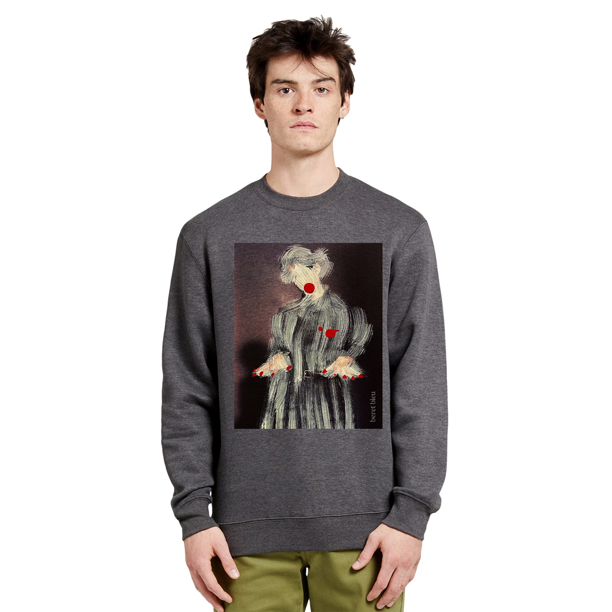 Front view of a man wearing a grey charcoal sweatshirt featuring a striking painting-style paintover graphic of a man or woman wearing a coat with red nails and red lips. This piece blends the world of art and fashion, standing out among trendy attires you only discover in artist studios.